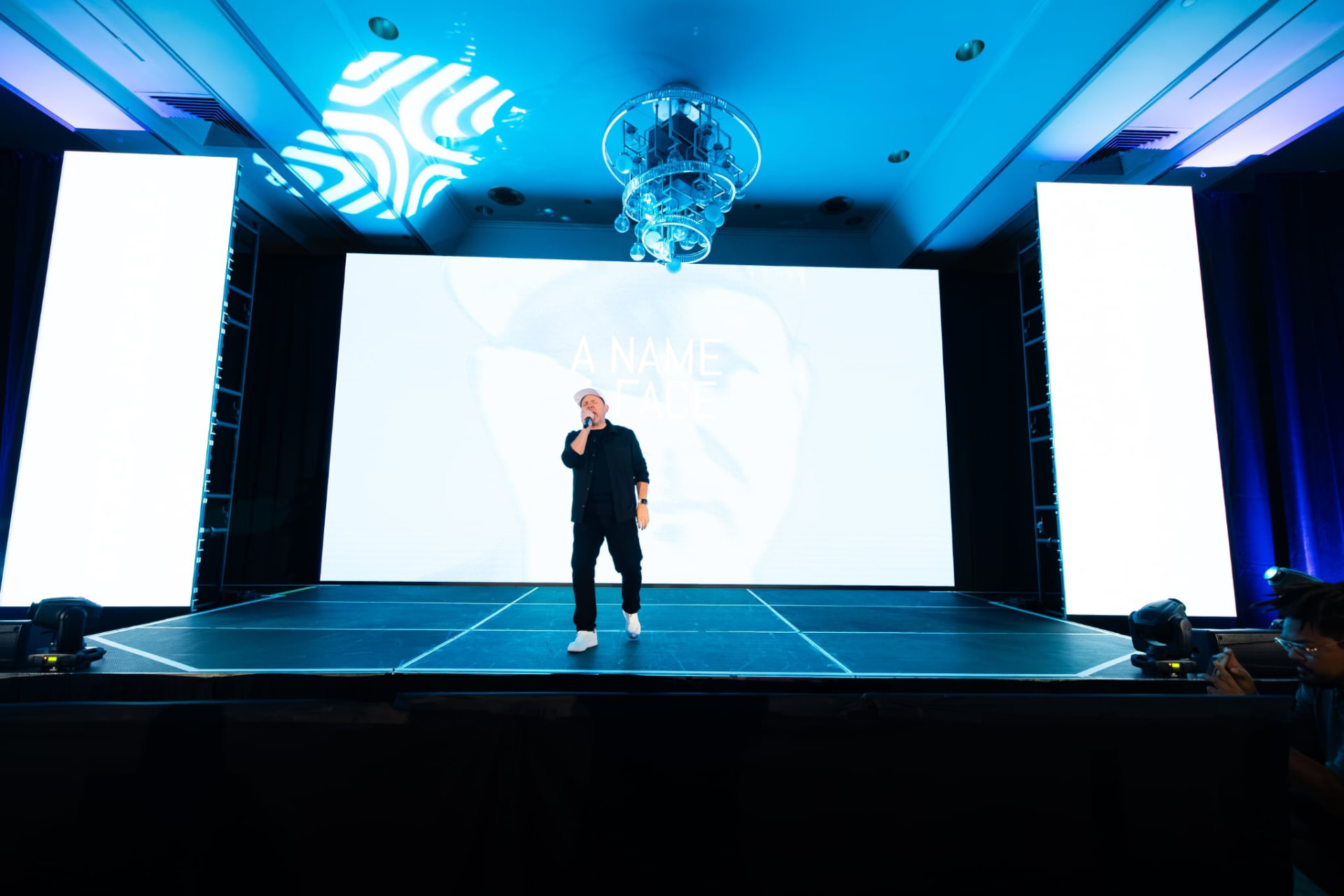 Michael King Jr. performing IRREPLACEABLE alone on the main stage under blue lights